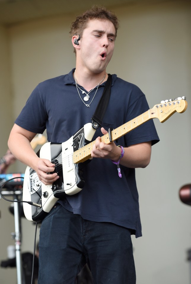 Sam Fender performing at Lollapalooza, playing an electric guitar.