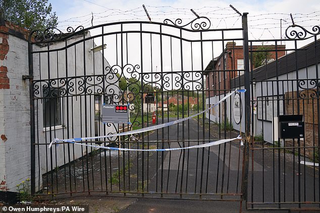 Police tape on the gate of the Fairfield Industrial Estate, which has been declared a crime scene