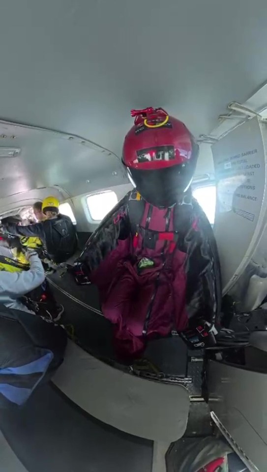 Skydiver preparing for a jump in a small plane.