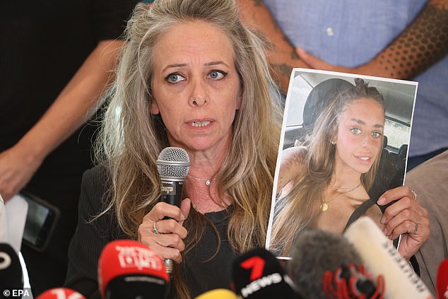 Keren Shelf, the mother of Israeli-French citizen Mia Shem, holds up a picture of her daughter during a press conference in Tel Aviv, Israel, 17 October 2023