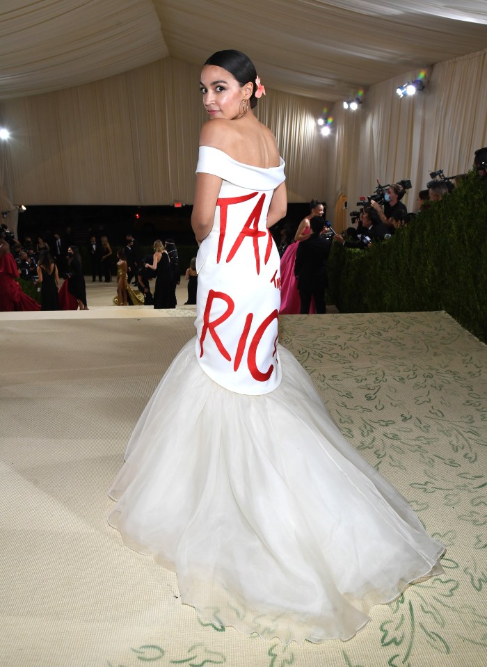 Alexandria Ocasio-Cortez at the Met Gala in a white gown with "Tax the Rich" written on the back.