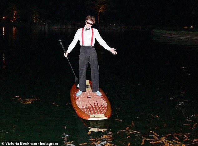 Another fun snap from the Cotswolds party showed Cruz paddle boarding in his socks and formal attire