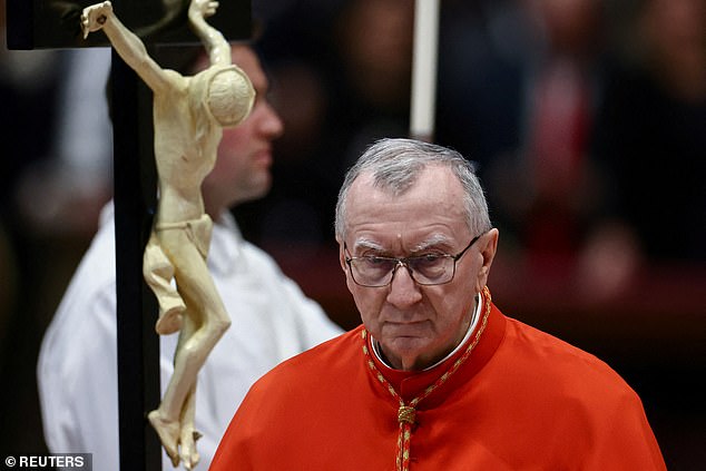 Pictured: Vatican's Secretary of State, Cardinal Pietro Parolin, walks after kissing the cross during the Good Friday Passion of the Lord service in Saint Peter's Basilica at the Vatican, April 18, 2025