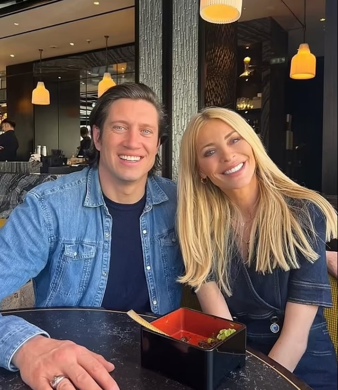 Tess Daly and a man sitting at a restaurant table.