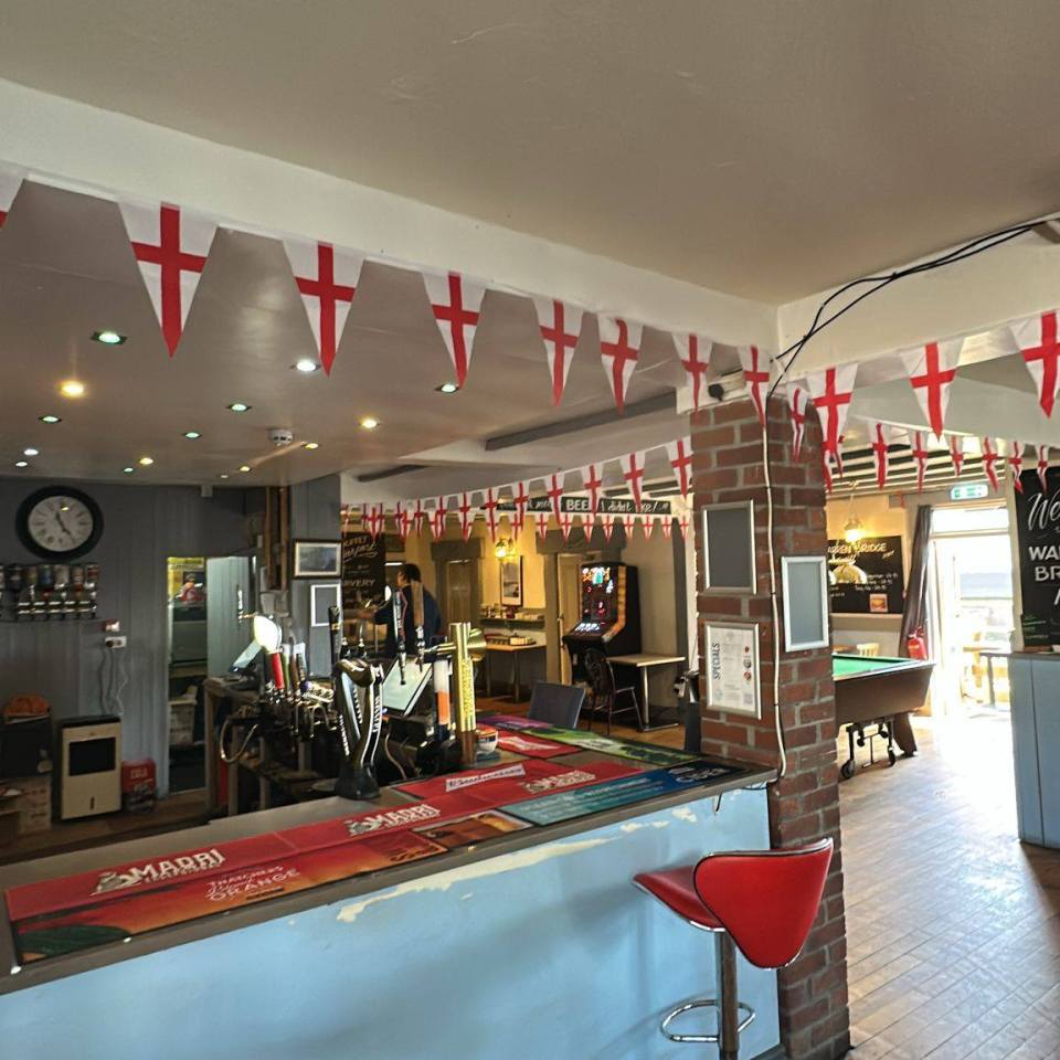 Interior view of the Warren Bridge Inn in Dawlish decorated with St. George's Cross flags.