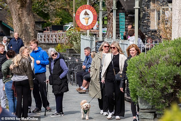 People walking in Ambleside village centre. Locals say the number of tourists has a negative impact on their day-to-day lives, from ditching cars to traffic jams