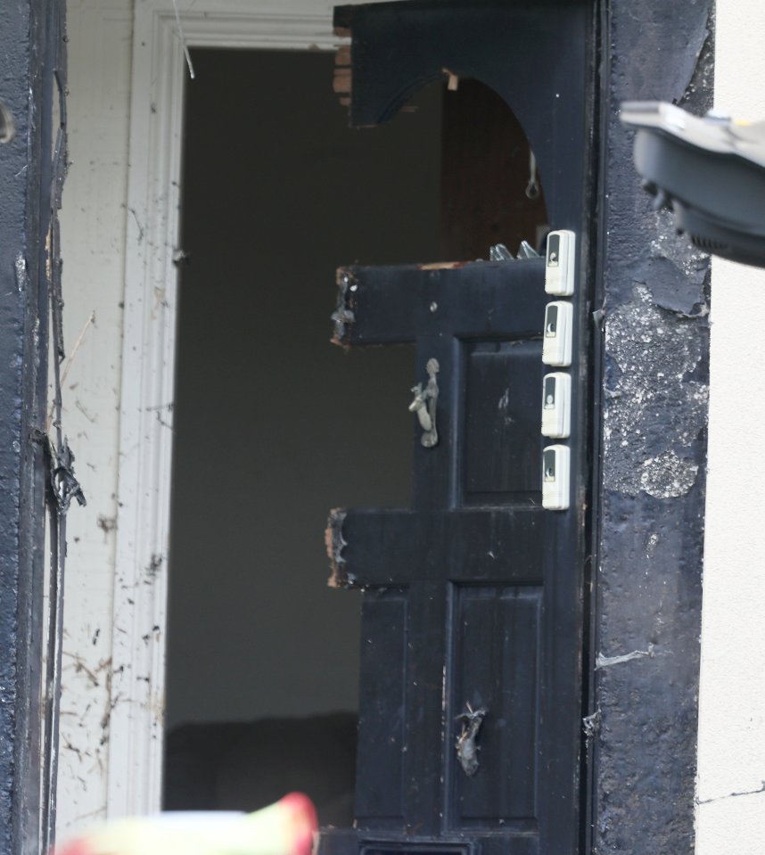 Damaged door after counter-terrorism raid.