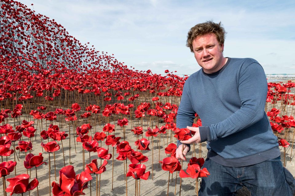 Artist Paul Cummins with his ceramic poppy sculpture, "Wave."