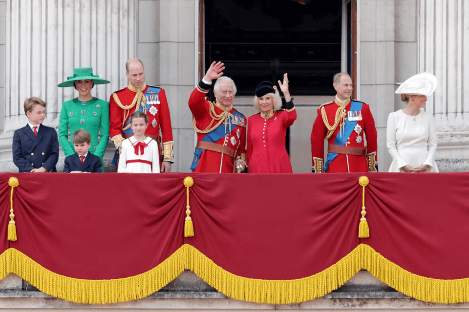 The royal family on a balcony waving.