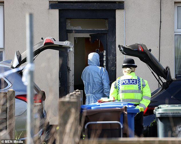 Police were yesterday questioning four men 'on suspicion of preparation of a terrorist act' after co-ordinated raids on addresses in west London, Rochdale, Swindon, Manchester and Stockport on Saturday evening. Pictured: Police in Rochdale following the counter terrorism raid