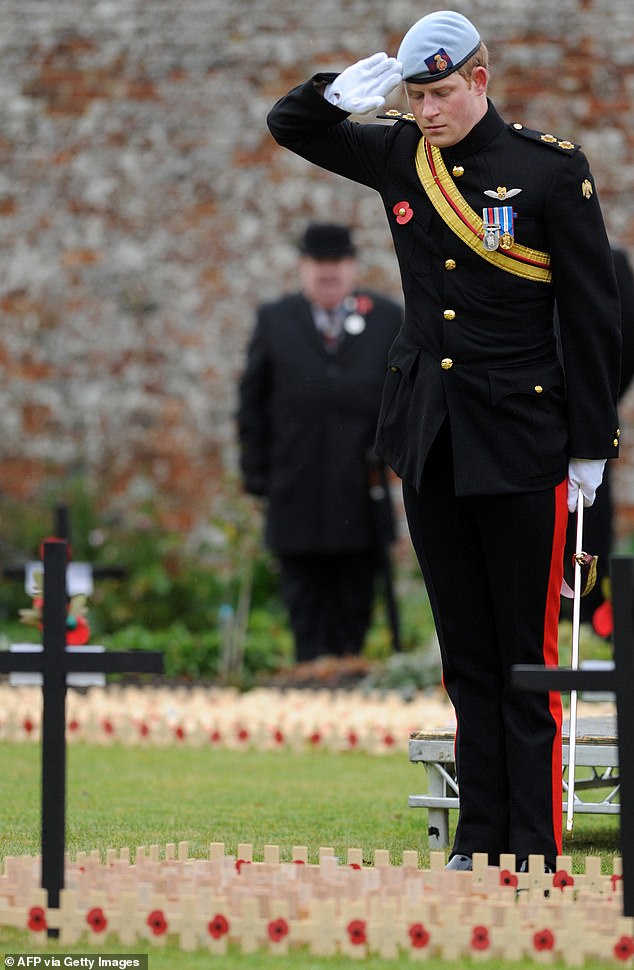 Prince Harry, salutes after laying cross of remembrance in memory of his friend Lance Corporal of Horse Jonathan Woodgate