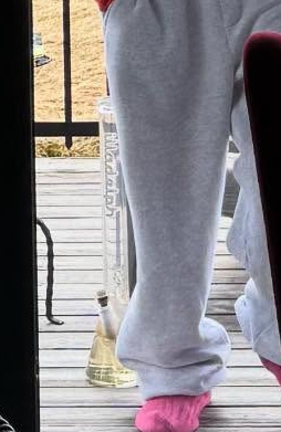 Person's legs and a bong.