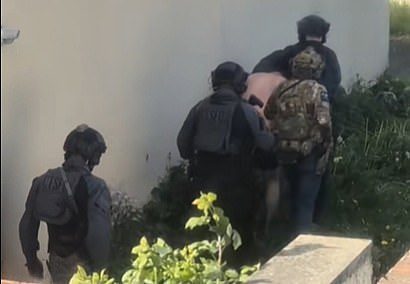 Counter terrorism specialist firearms officers, thought to be dressed in black and grey tactical gear, are seen detaining a suspect in Rochdale over the weekend