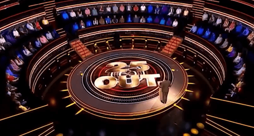 "25 to Out" game show set with audience and host.