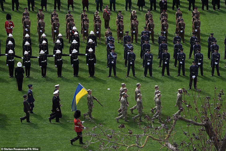 Ukrainian soldiers take up their position in Parliament Square this morning ahead of the military procession in London