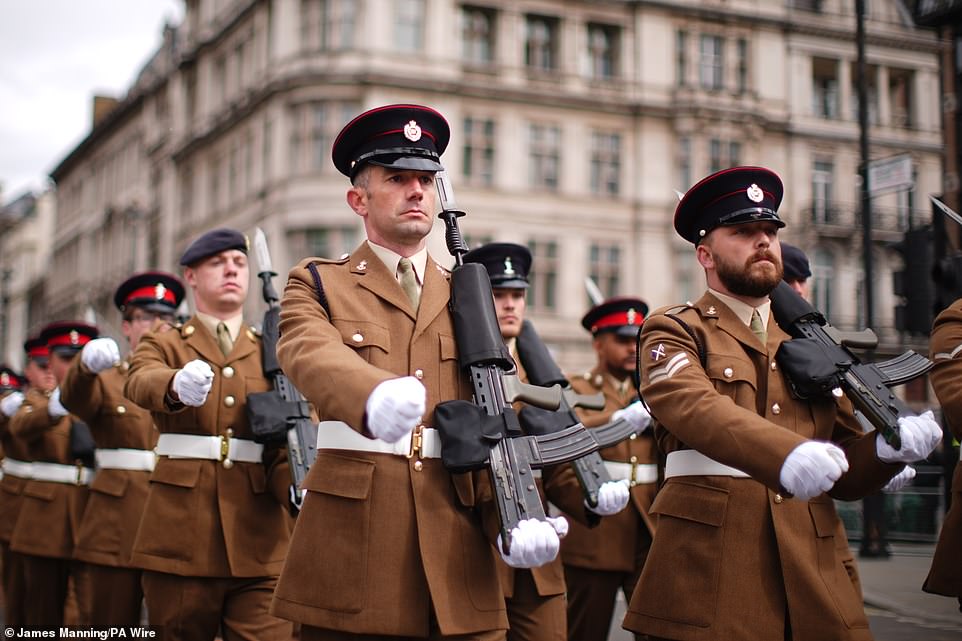 Members of the military march past Parliament Square in London this morning to mark the 80th anniversary of VE Day