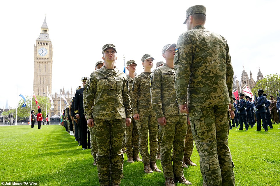 Ukrainian soldiers take up their position in Parliament Square this morning ahead of the military procession in London