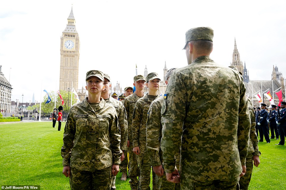 Ukrainian soldiers take up their position in Parliament Square this morning ahead of the military procession in London