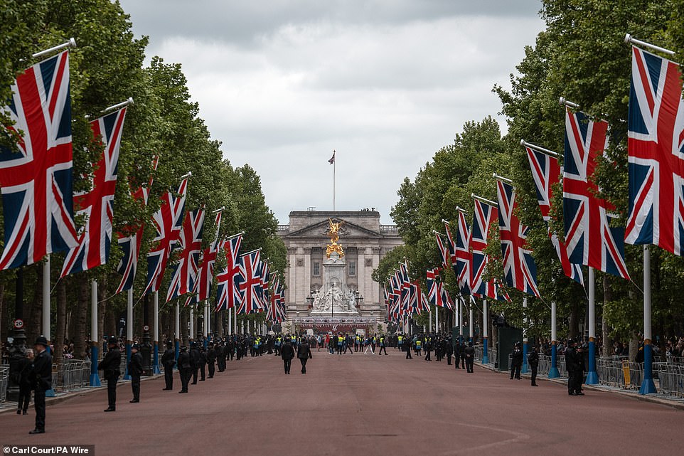 People gather on The Mall this morning ahead of a military procession marking the 80th anniversary of VE Day in London
