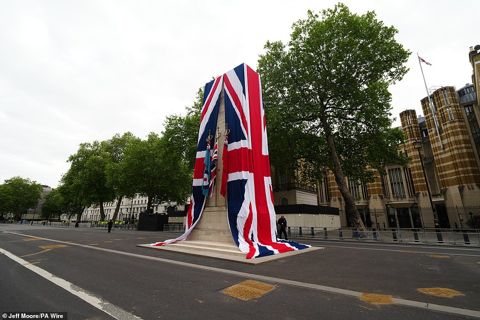 The Cenotaph on Whitehall is dressed in the Union flag as final preparations are made ahead of the military procession today