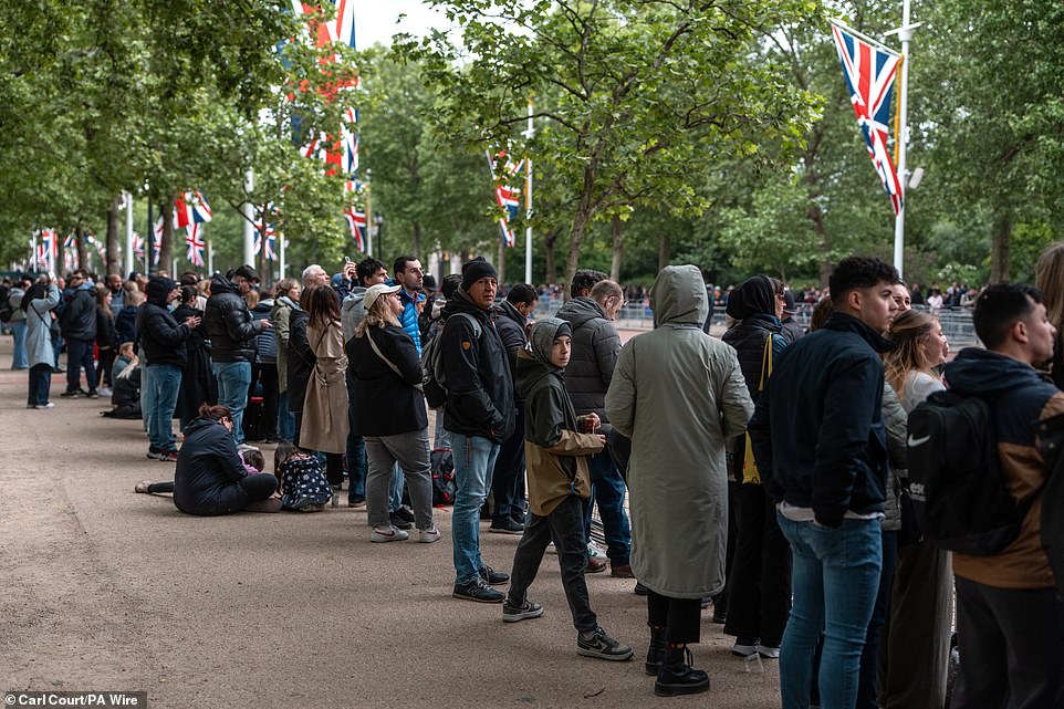 People gather on The Mall this morning ahead of a military procession marking the 80th anniversary of VE Day in London
