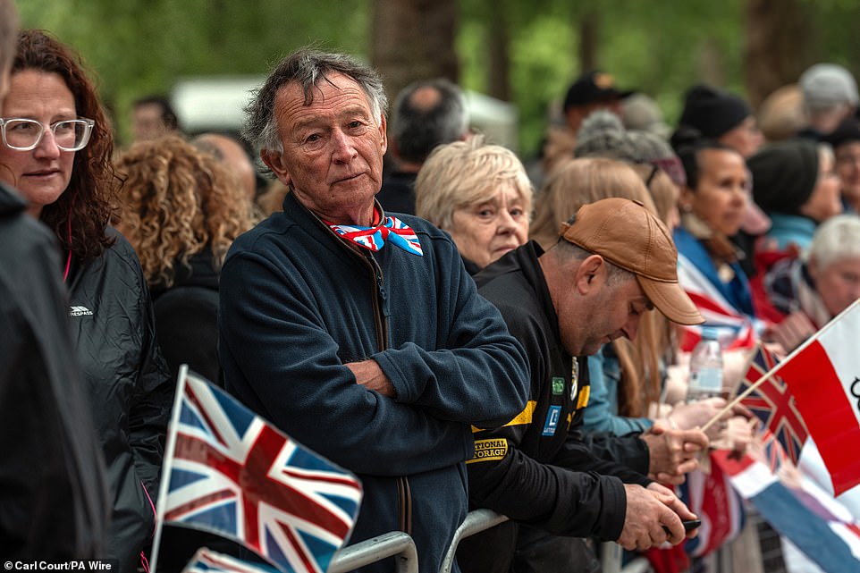 People gather on The Mall this morning ahead of a military procession marking the 80th anniversary of VE Day in London