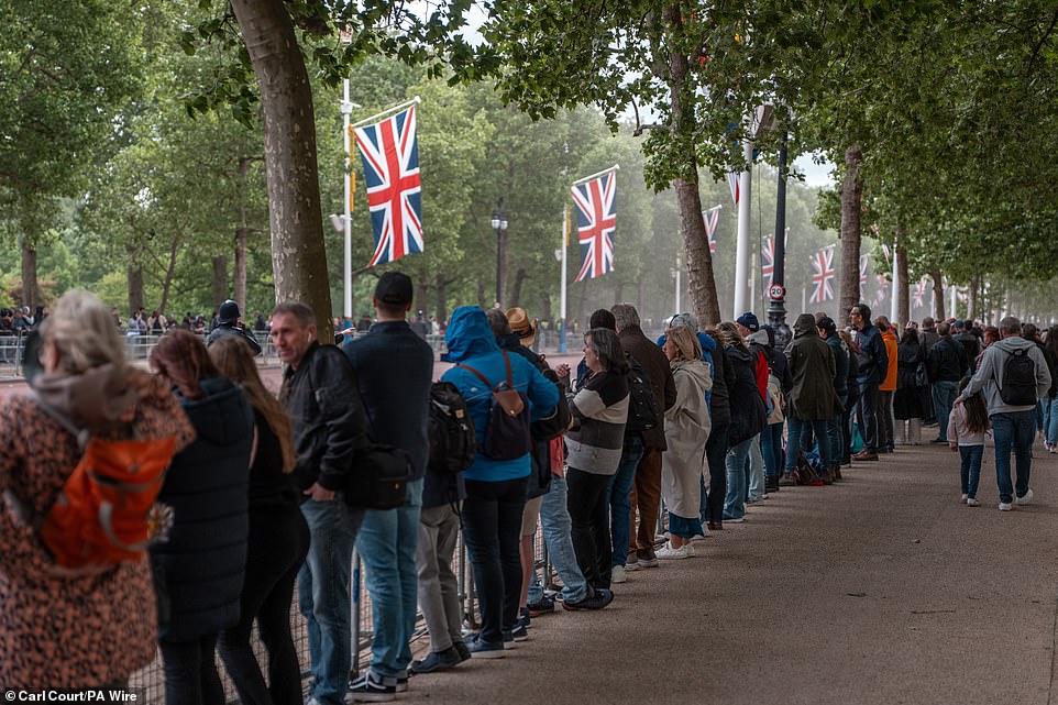 People gather on The Mall this morning ahead of a military procession marking the 80th anniversary of VE Day in London