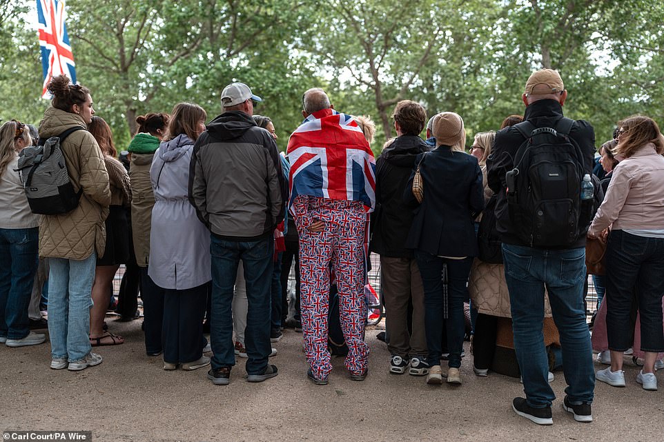 People gather on The Mall this morning ahead of a military procession marking the 80th anniversary of VE Day in London