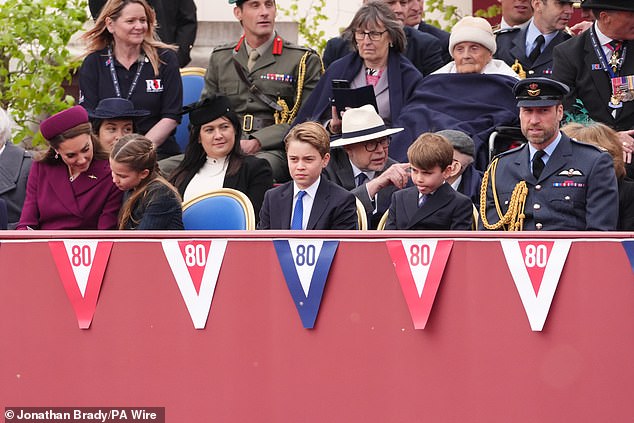 While his family sat and watched the parade, Prince Louis was up to his old tricks as he playfully stuck out his tongue