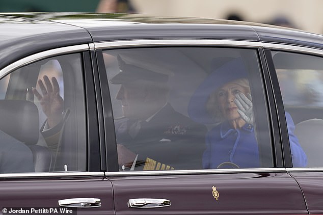 King Charles III and Queen Camilla arrive for the military procession marking the 80th anniversary of VE Day in London today
