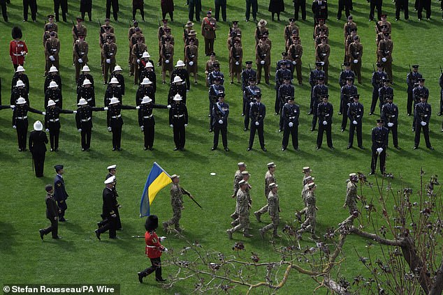 Ukrainian soldiers take up their position in Parliament Square this morning ahead of the military procession in London