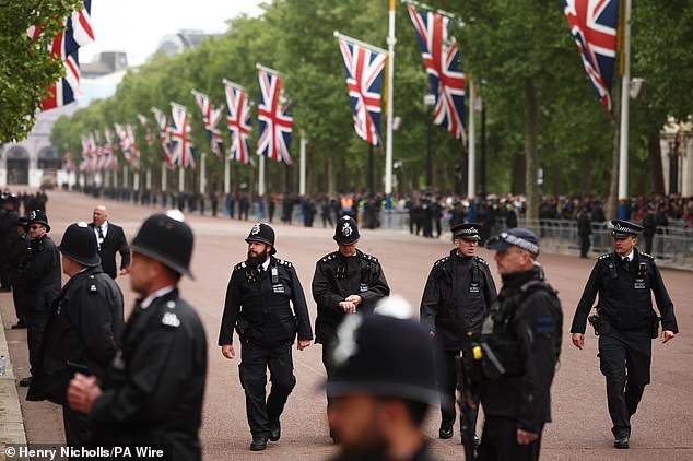 Police officers walk down The Mall this morning ahead of a military procession marking the 80th anniversary of VE Day