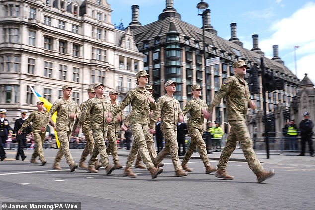 Members of the Ukrainian military march past Parliament Square this morning to mark the 80th anniversary of VE Day