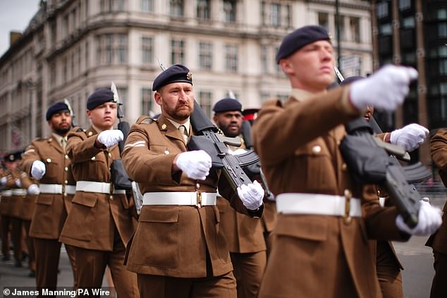 Members of the military march past Parliament Square in London this morning to mark the 80th anniversary of VE Day