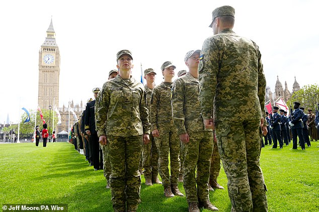Ukrainian soldiers take up their position in Parliament Square this morning ahead of the military procession in London