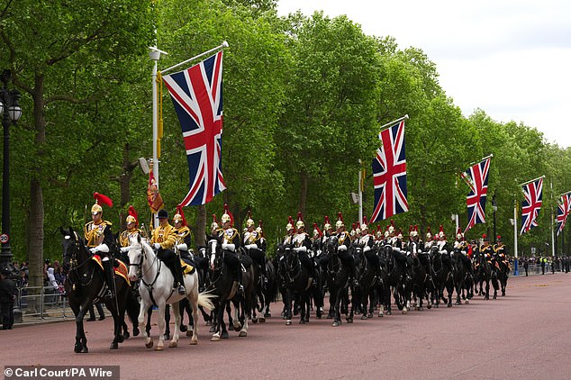 Members of the Household Cavalry Regiment parade on The Mall this morning ahead of the military procession