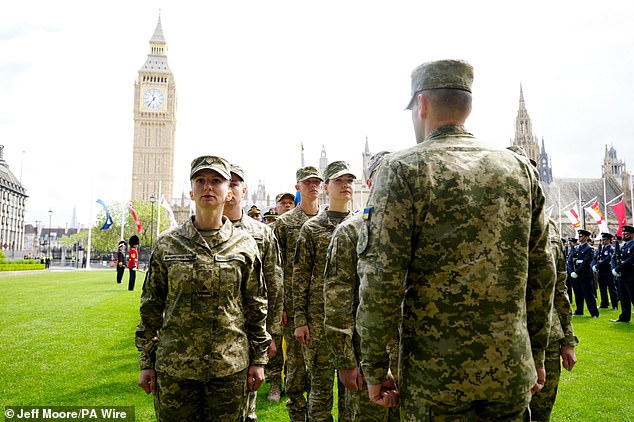 Ukrainian soldiers take up their position in Parliament Square this morning ahead of the military procession in London