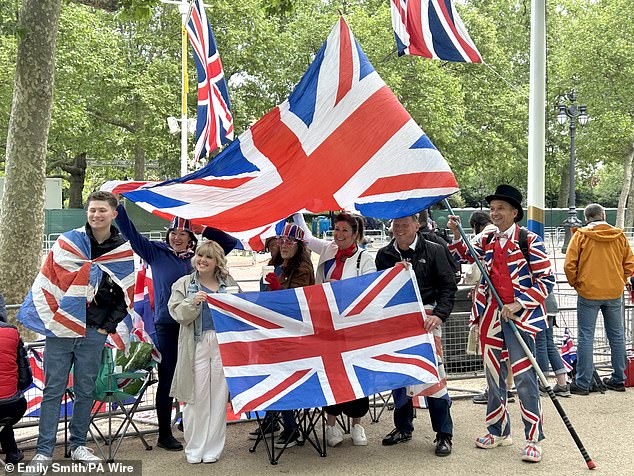 Michael Burn (right), 67, from Watford, joins the crowds at The Mall today. Dressed head to toe in a Union flag suit he said: 'Obviously I'm very patriotic so I make the most of any of these events, the coronation or anything like that I'll be here'