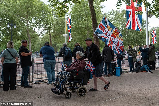 People gather on The Mall this morning ahead of a military procession marking the 80th anniversary of VE Day in London