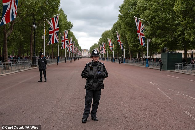 Police officers guard The Mall this morning ahead of a military procession marking the 80th anniversary of VE Day