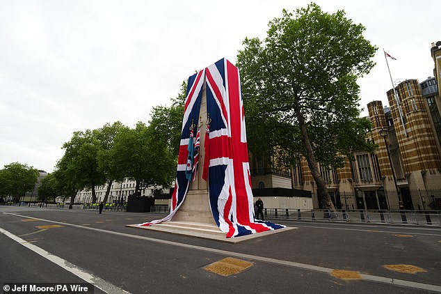 The Cenotaph on Whitehall is dressed in the Union flag as final preparations are made ahead of the military procession today