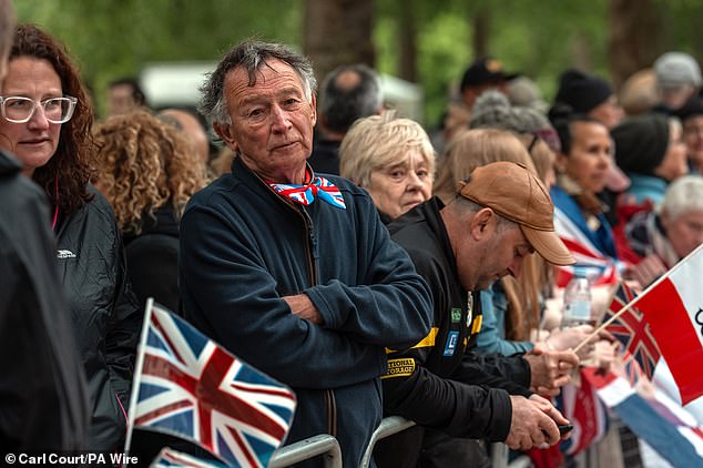 People gather on The Mall this morning ahead of a military procession marking the 80th anniversary of VE Day in London