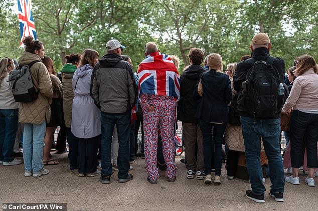 People gather on The Mall this morning ahead of a military procession marking the 80th anniversary of VE Day in London