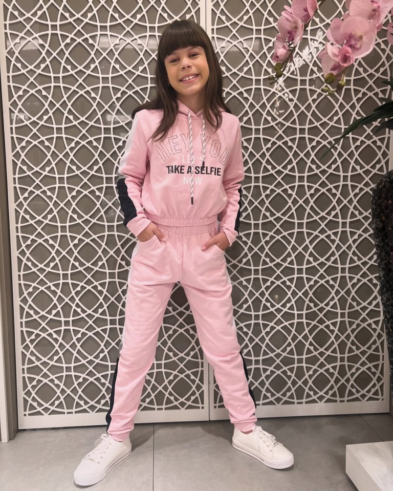 Girl in pink tracksuit.