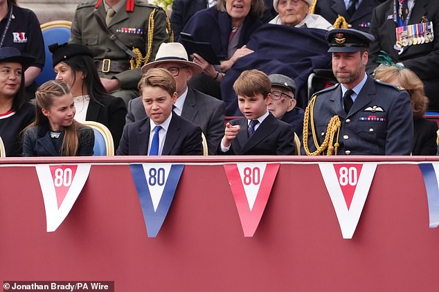 Princess Charlotte smling at her younger brother, Louis, as he observed the parade