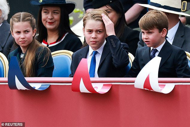 Prince George, Prince Louis and Princess Charlotte watch the procession to mark the 80th anniversary of VE Day today