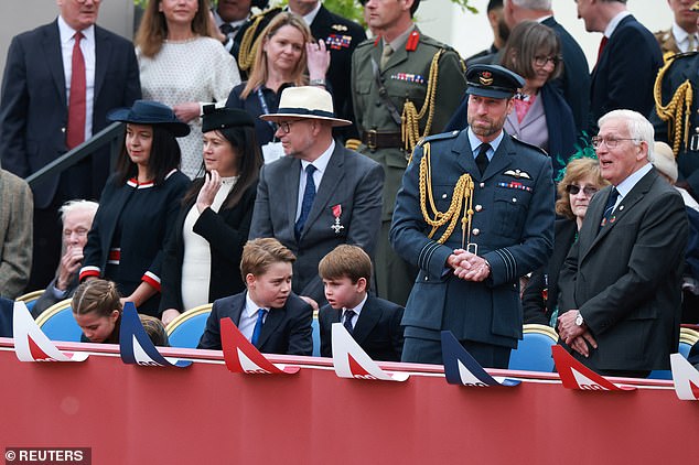 Prince William stands next to Prince George, Prince Louis and Princess Charlotte at the VE Day parade in London today
