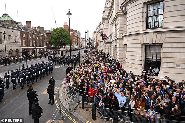 People watch an armed forces and veterans' parade commemorating the 80th anniversary of VE Day in London today