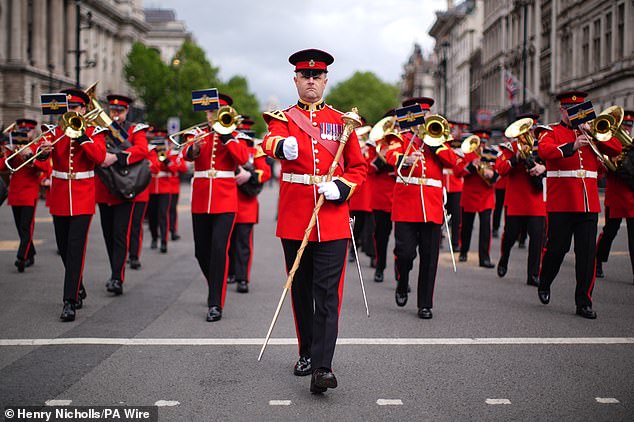 Members of military band march in Parliament Square today ahead of the military procession marking VE Day 80