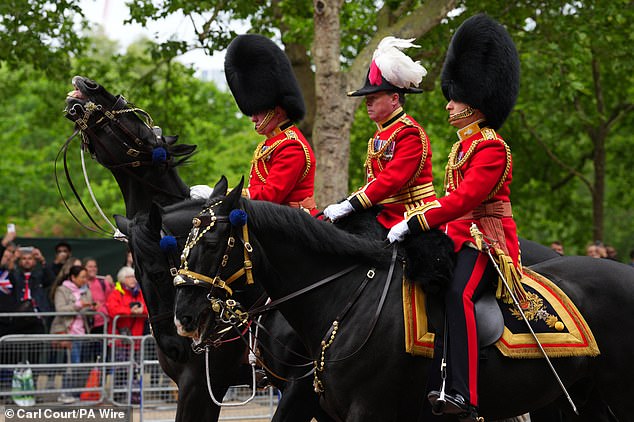 Members of the Household Division parade on The Mall ahead of the military procession through London today